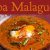 Plato hondo con sopa malagueña de espárragos trigueros, pan cateto y hebras de azafrán Antonio Sotos sobre mesa rústica.