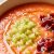 Plato hondo con salmorejo de melón amarillo decorado con hebras de azafrán Antonio Sotos, crujiente de jamón ibérico y un hilo de aceite de oliva.